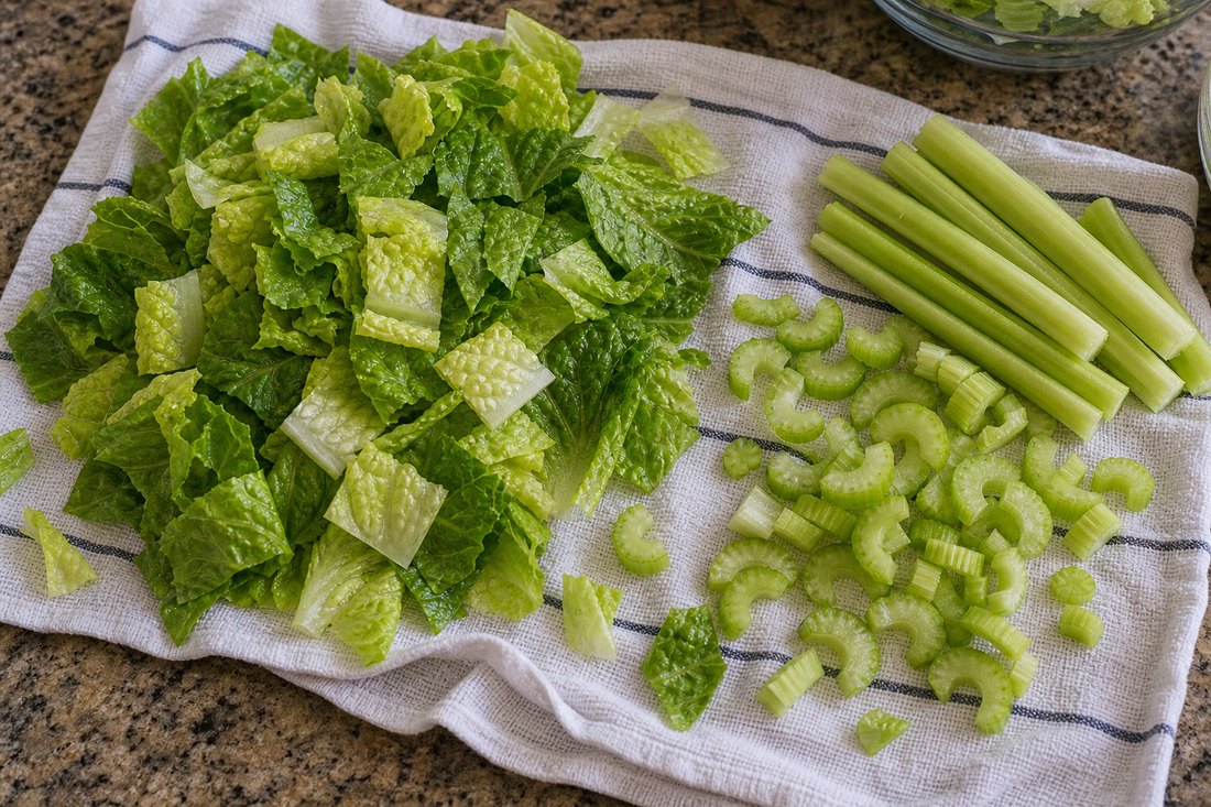 Dry chopped romaine and celery prepared for buffalo chicken salad.