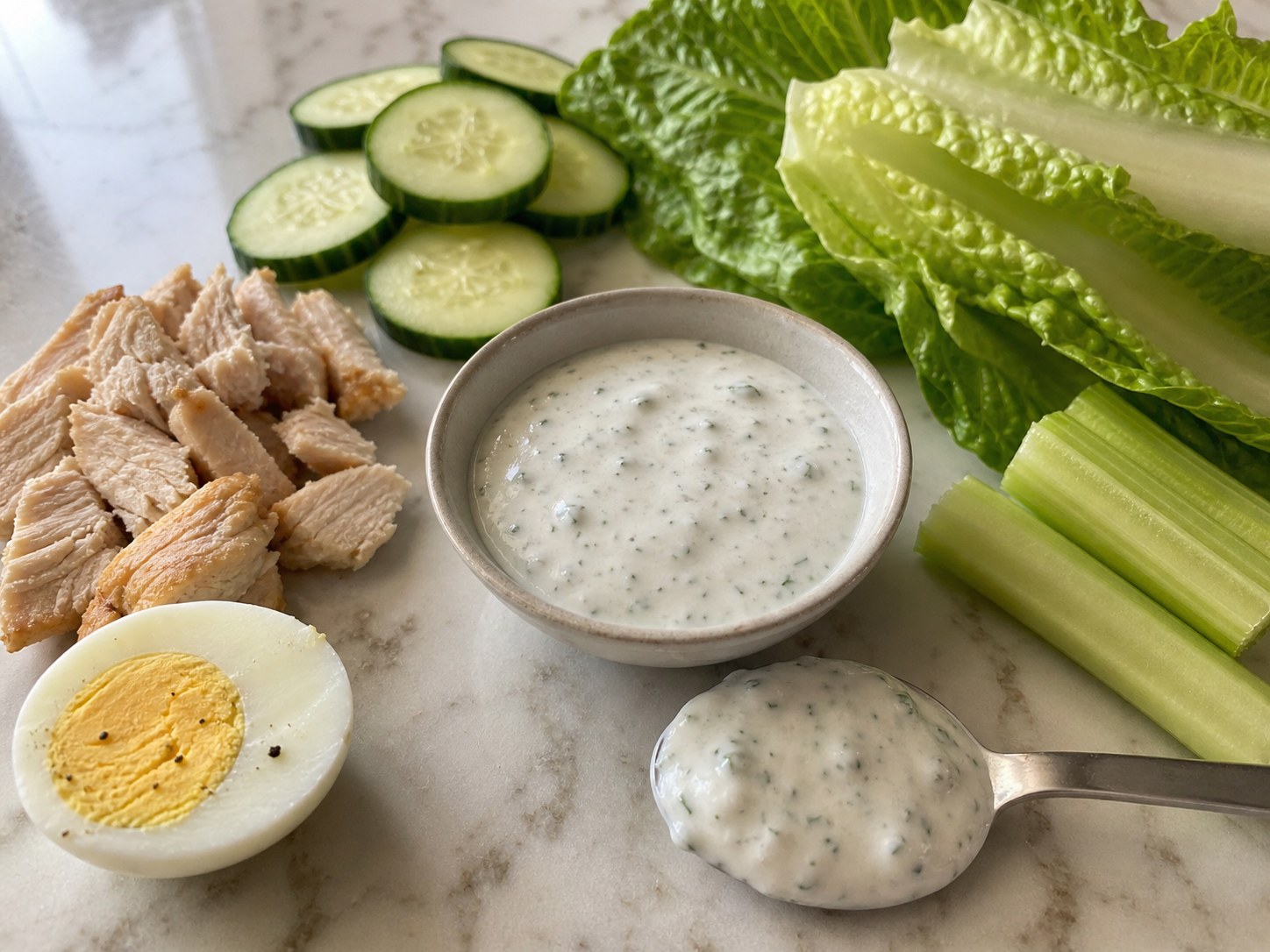 Greek yogurt ranch tasted with cold cucumber, romaine, celery, chicken, and boiled egg.