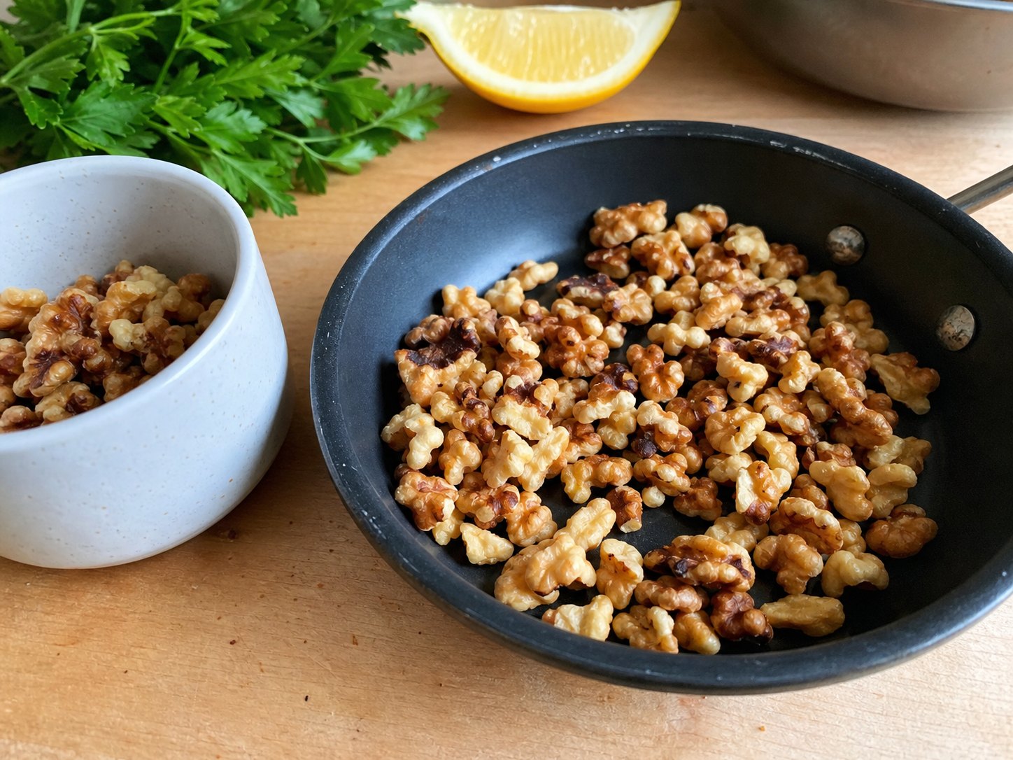 Toasted walnuts kept dry in a small cup for finishing lentil lemon Dijon salad.