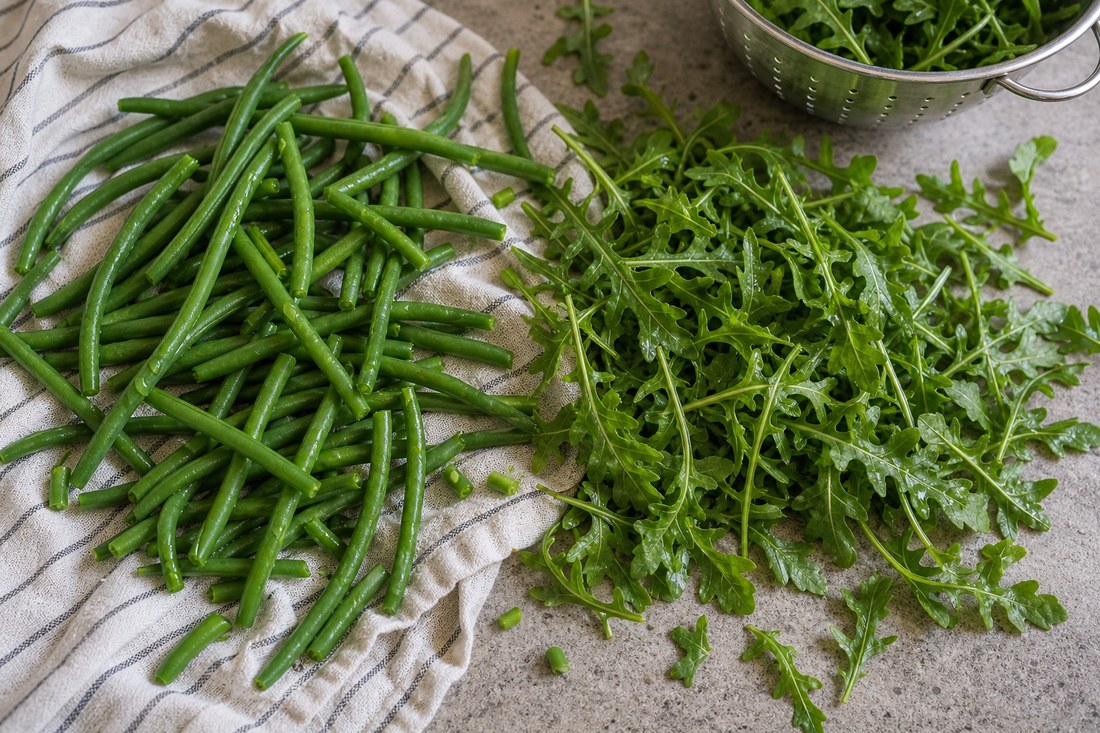 Green beans and arugula prepared casually for steak potato salad.
